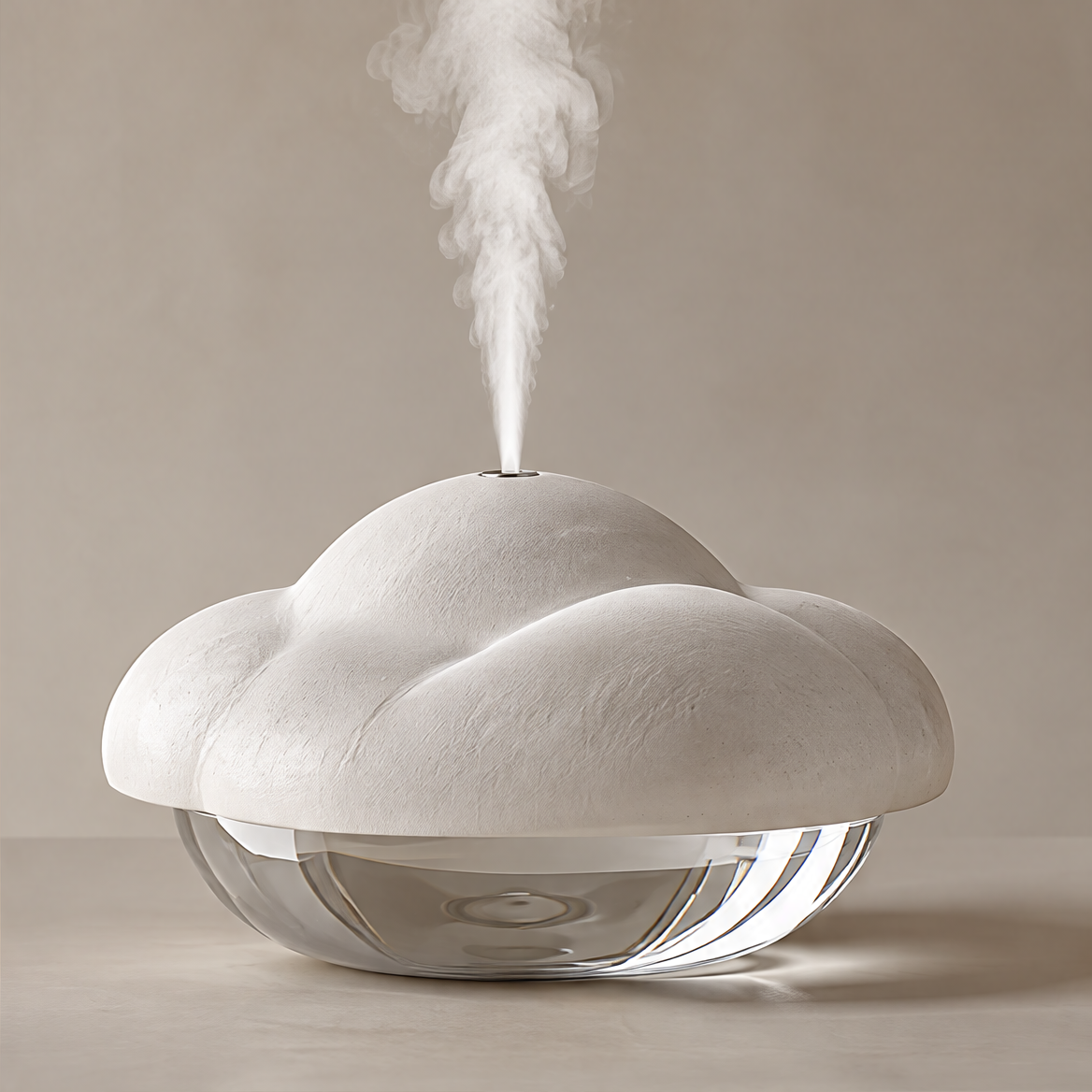 Cloud-shaped humidifier with an off-white textured top, transparent rounded base and rising mist on a plain background.